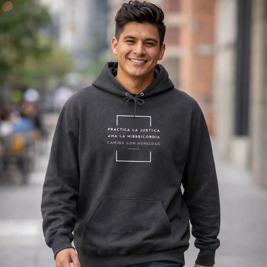 Woman wearing a navy Christian hoodie with Spanish Bible verse and dove graphic, casual setting