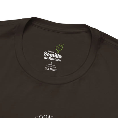 Close-up of black Christian t-shirt label with 'Semilla de Mostaza' text and care symbols