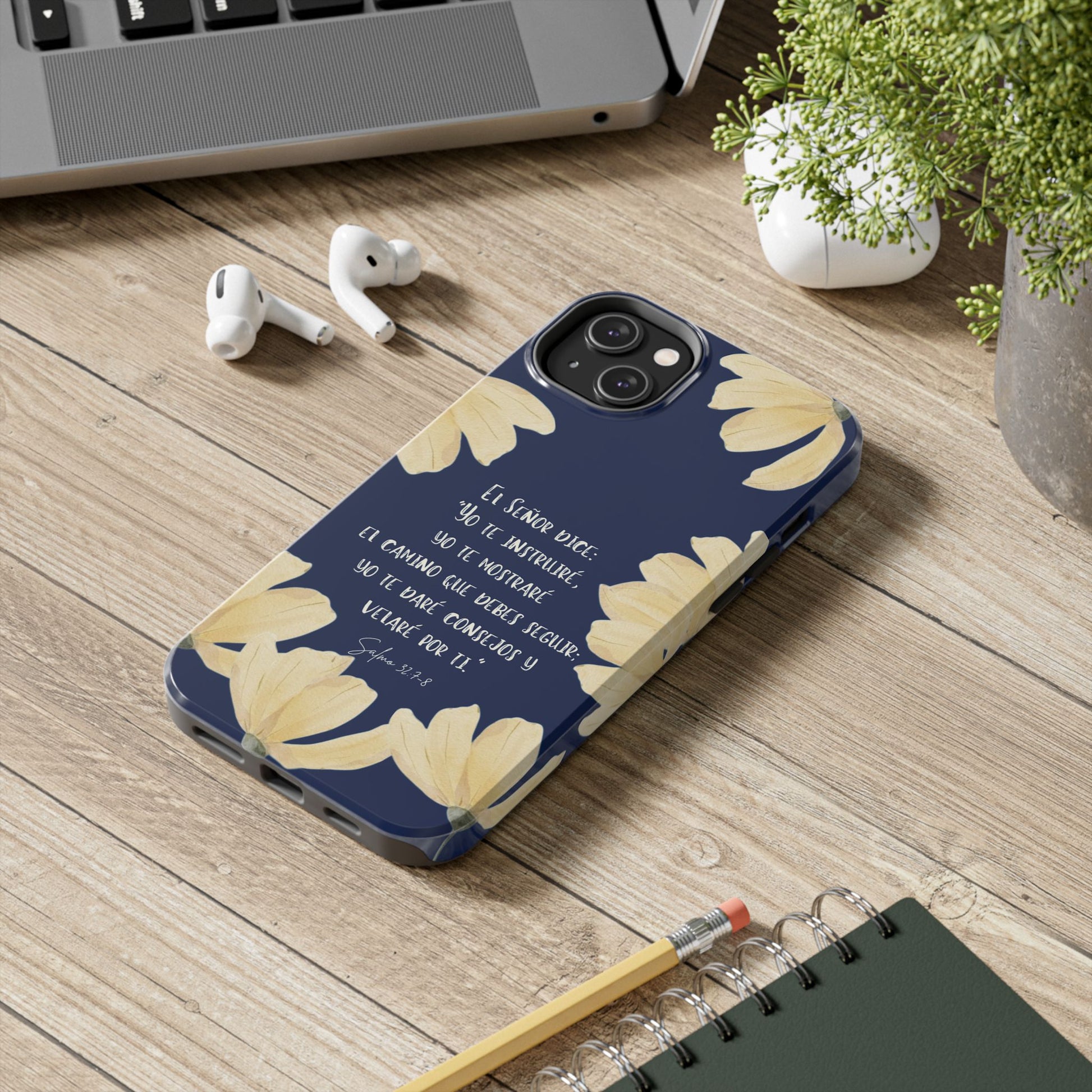 Christian phone case with Spanish scripture and yellow flower design on desk