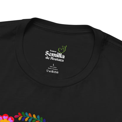 Black Christian t-shirt with floral detail and 'Somos Semilla de Mostaza' text at collar