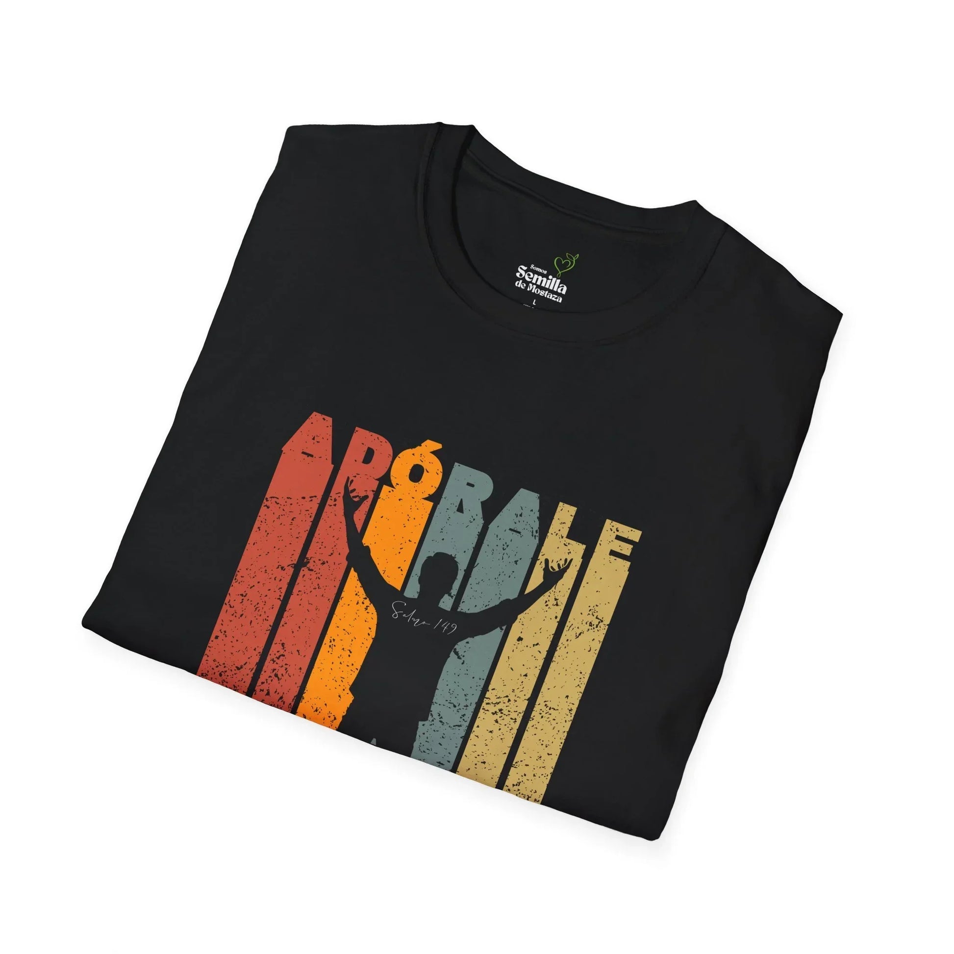 Folded black Christian t-shirt with 'Adórale' text, silhouette worshipper, and retro stripes.