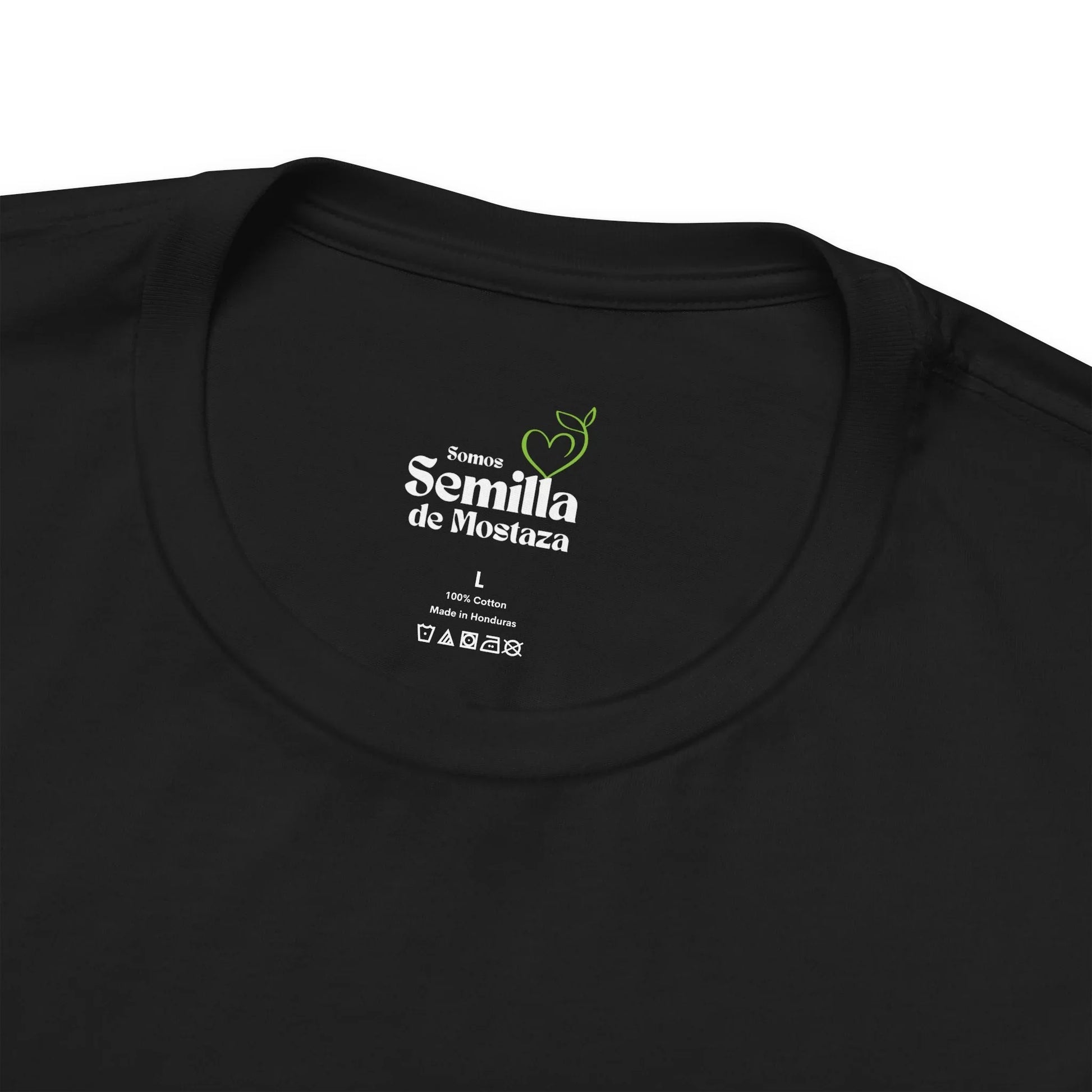 Close-up of black Christian t-shirt collar with 'Somos Semilla de Mostaza' printed inside
