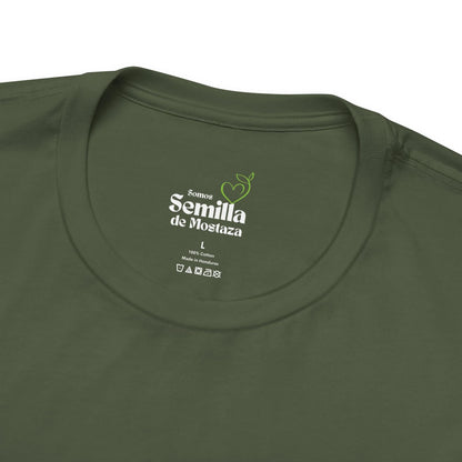 Olive green Christian t-shirt with 'Somos Semilla de Mostaza' label and care symbols.