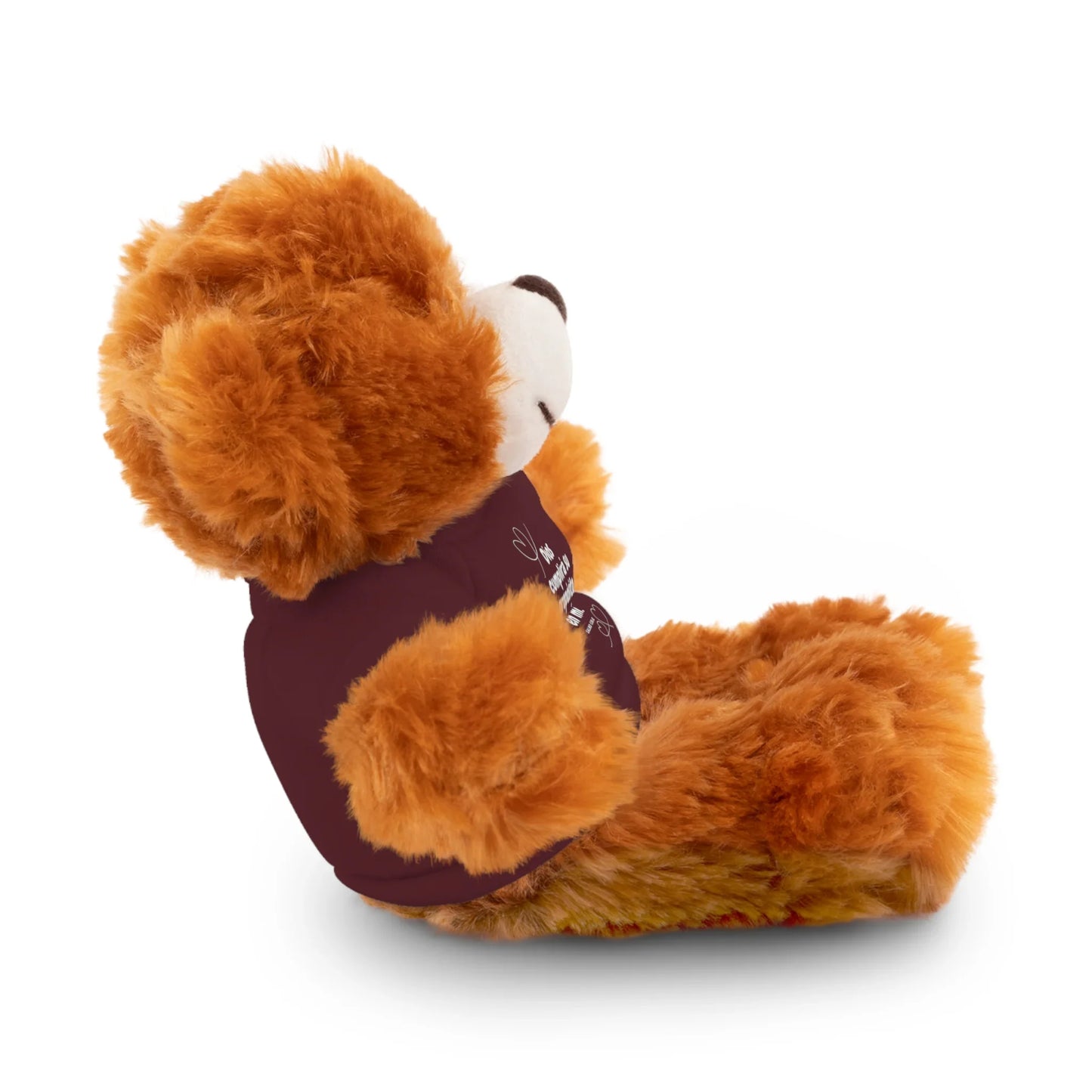 Plush teddy bear in a maroon shirt with Christian design, sitting on white background