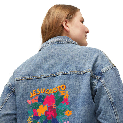 Woman wearing denim jacket with JESUCRISTO and colorful floral Christian design on back
