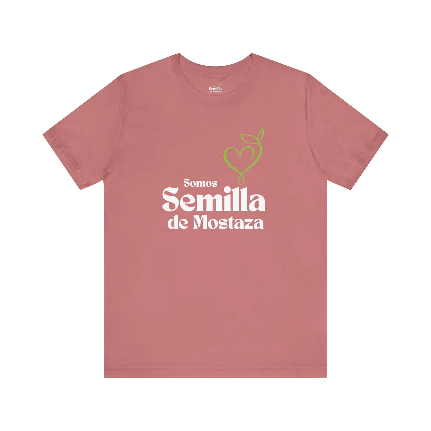 Pink Christian t-shirt with 'Somos Semilla de Mostaza' and green heart-shaped sprout graphic.