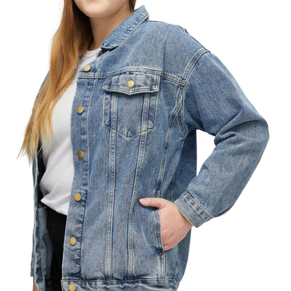 Woman wearing a classic blue denim jacket over a white shirt, hand in pocket