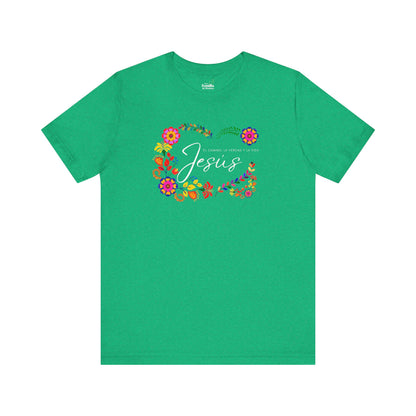 Green Christian t-shirt with 'Jesus' text, Scripture, and colorful floral design.