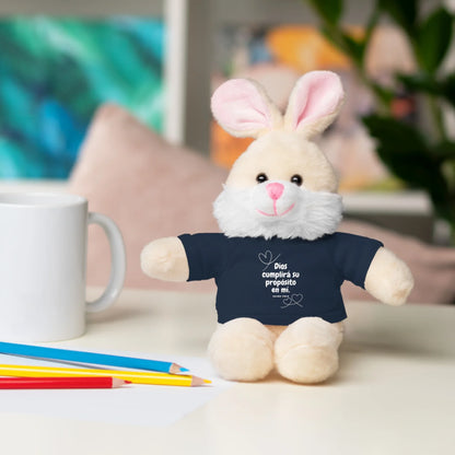 Plush bunny with Christian shirt on desk, next to mug and colored pencils