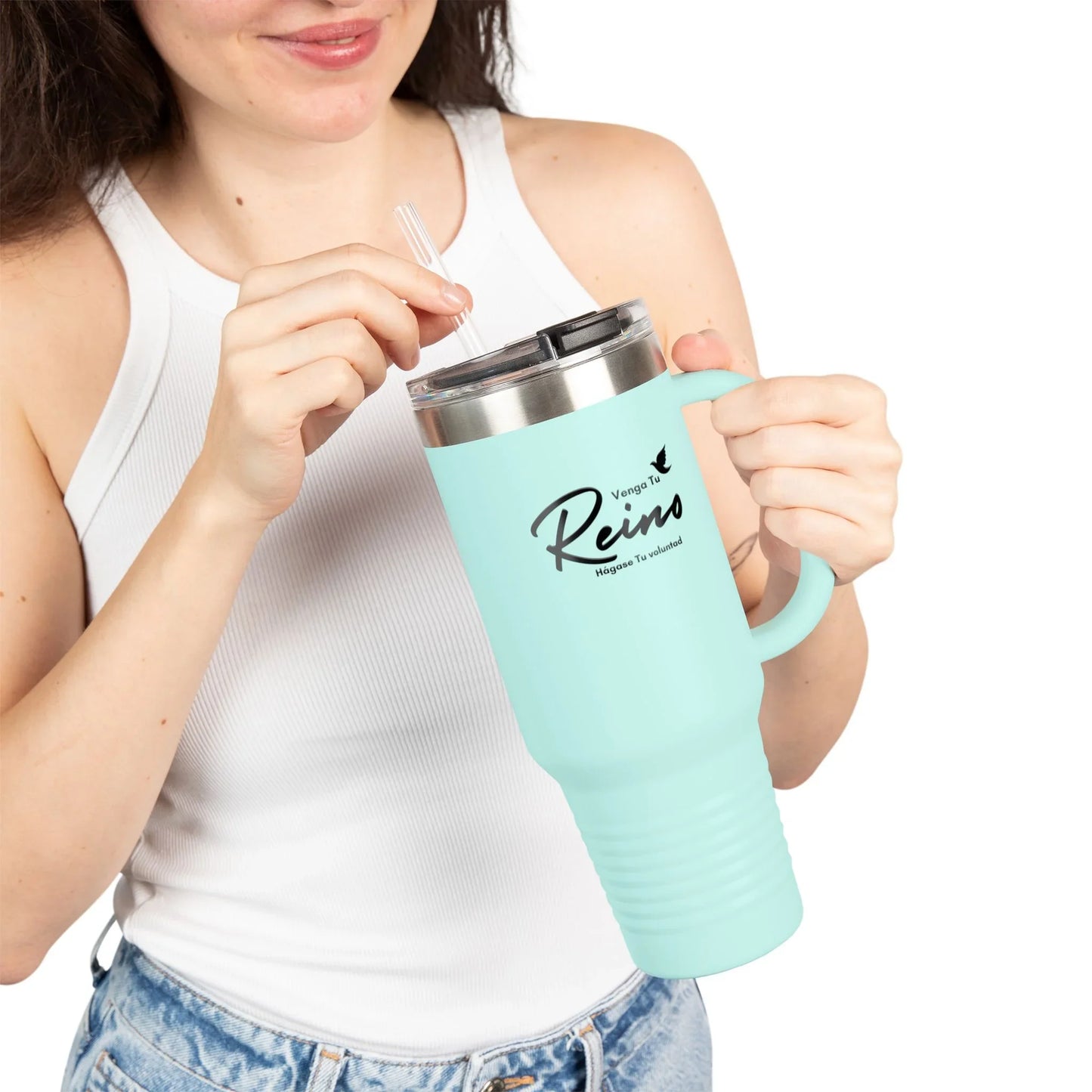 Woman holding light blue Christian travel mug with Spanish faith quote, wearing white tank top