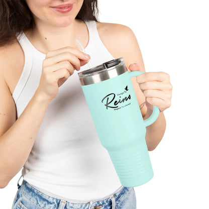 Woman holding light blue Christian travel mug with Spanish faith quote, wearing white tank top