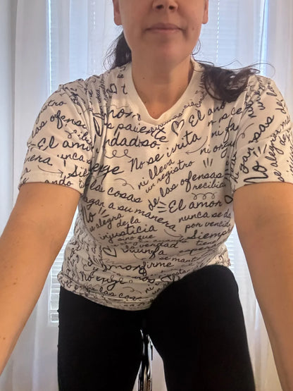 Woman in handwritten script Christian graphic tee with inspirational Spanish text, indoors
