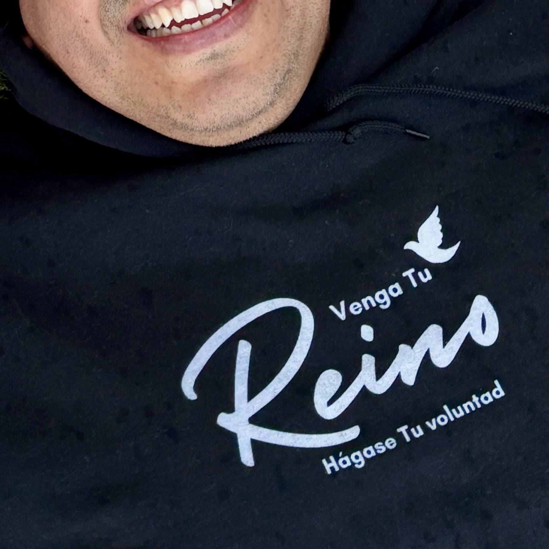 Black Christian hoodie with Spanish faith message 'Venga Tu Reino, Hágase Tu voluntad' and dove.