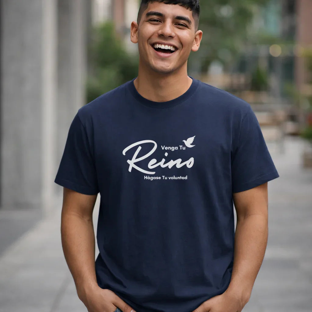 Smiling man outdoors wearing navy Christian t-shirt with Venga Tu Reino faith message in Spanish