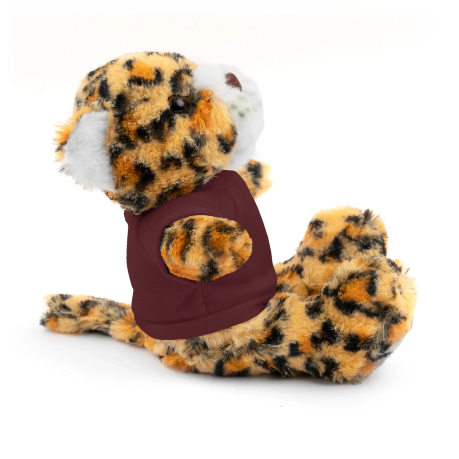 Plush leopard toy wearing a maroon shirt, sitting on white background