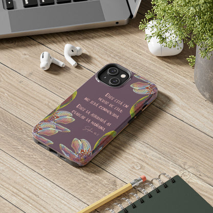 Purple Christian phone case with Spanish Scripture and floral design on a desk with accessories
