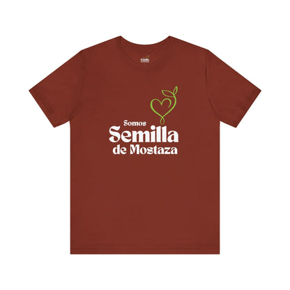 Rust brown Christian t-shirt with 'Somos Semilla de Mostaza' and green heart sprout graphic.