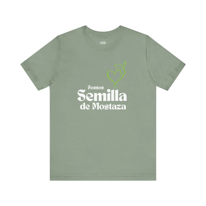 Sage green Christian t-shirt with 'Somos Semilla de Mostaza' and a heart sprout graphic.