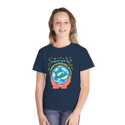 Smiling girl in navy Christian t-shirt with globe and Spanish Bible verse graphic