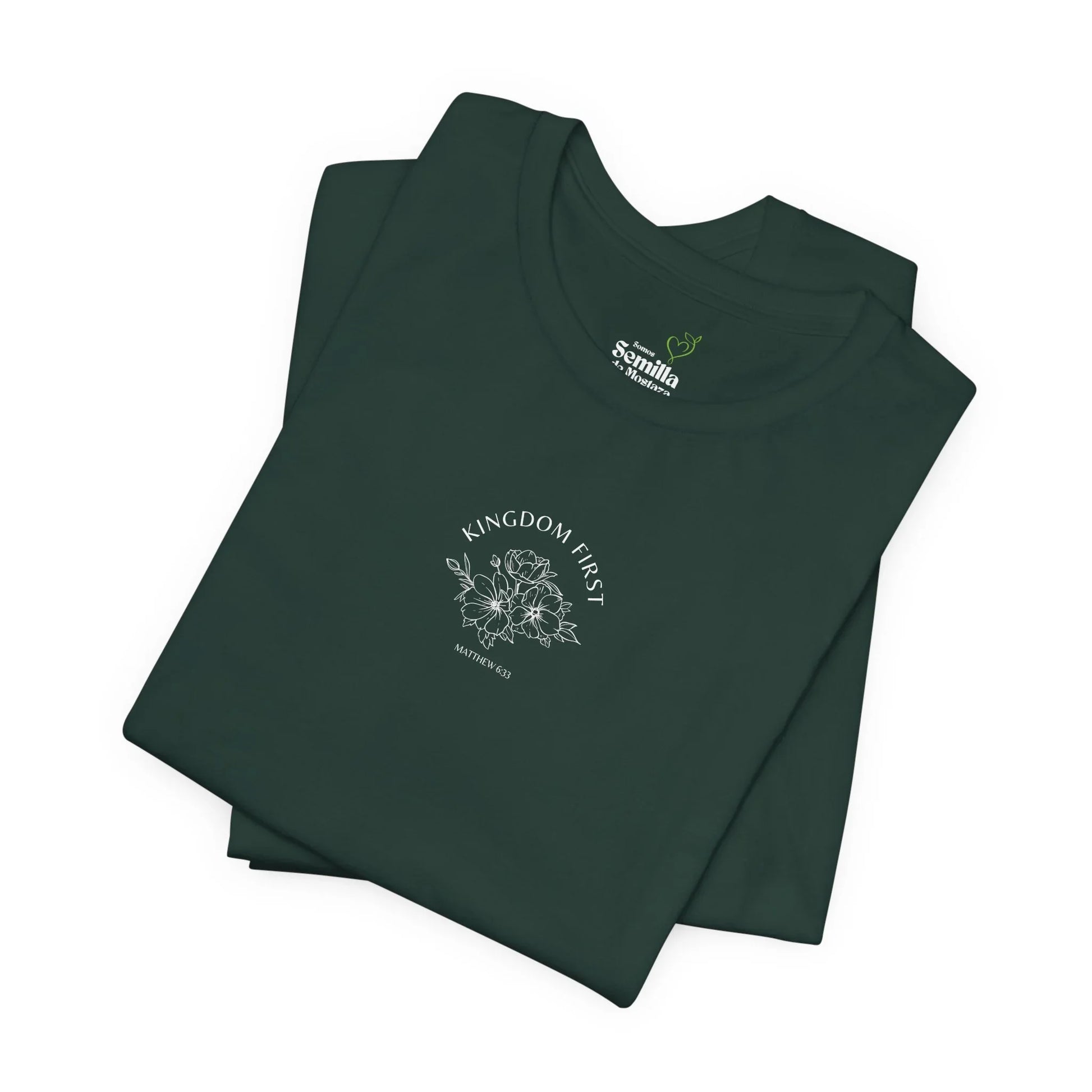 Folded dark green Christian t-shirt with 'Kingdom First' and floral design on front