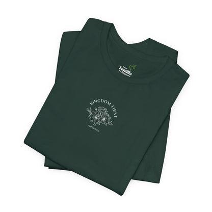Folded dark green Christian t-shirt with 'Kingdom First' and floral design on front