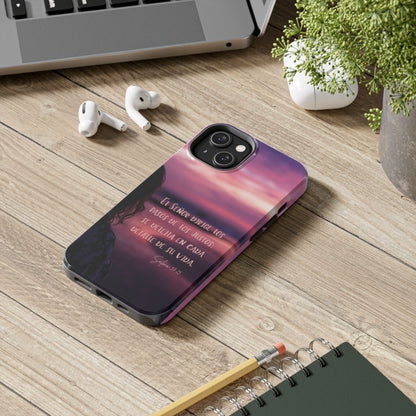 Christian phone case with Spanish Scripture on desk with laptop, plant, AirPods, and notebook.