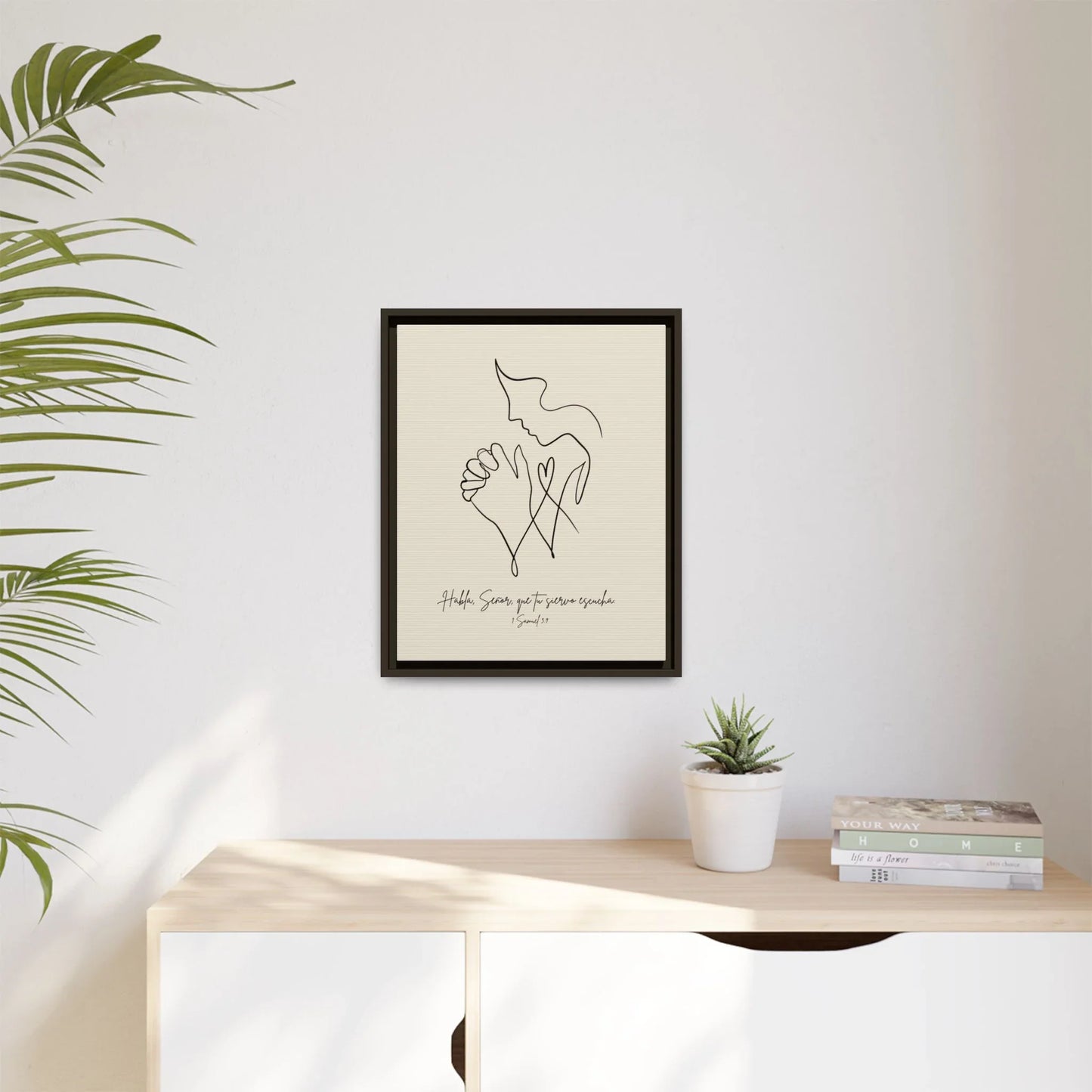 Minimalist Christian wall art with praying hands above a modern sideboard, home décor