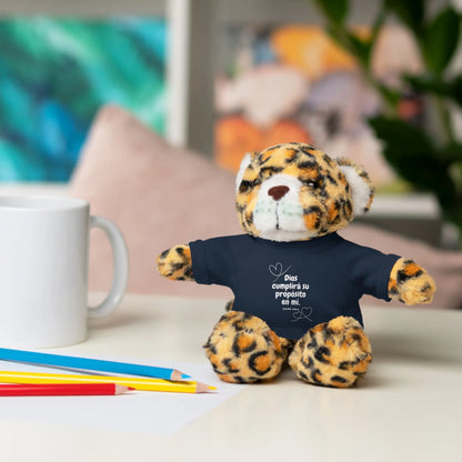 Leopard plush toy in Christian t-shirt with Spanish Scripture, on desk with mug and pencils.