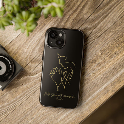 Black phone case with gold line art of praying hands and scripture, on rustic wood table