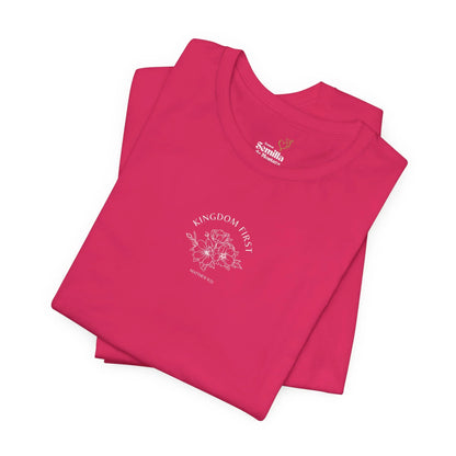 Hot pink Christian t-shirt with floral design and 'Kingdom First, Matthew 6:33' text.