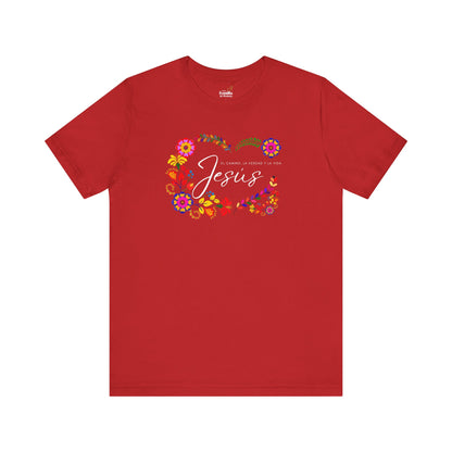 Red Christian t-shirt with 'Jesús' text, floral design, and Spanish Bible verse.